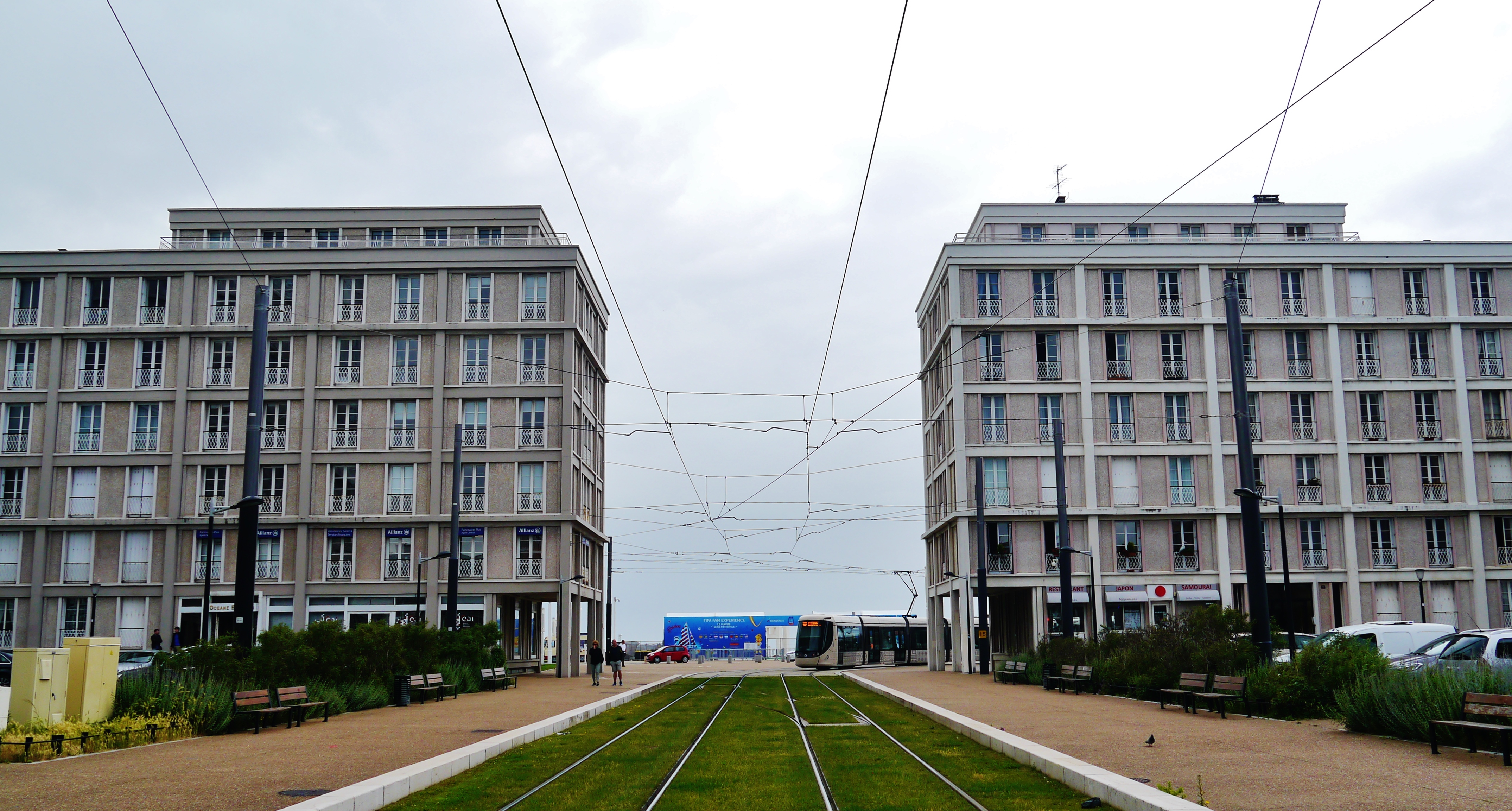 Two identical mid-20th century buildings with a grassed tramway passing between them